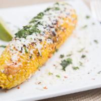 Street Corn · Char grilled corn (off the cob), chipotle sauce, queso fresco, and lime.