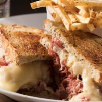 Our Famous Grilled Reuben Sandwich · Corned beef and pastrami or oven-gold roasted turkey breast steamed and piled high with saue...
