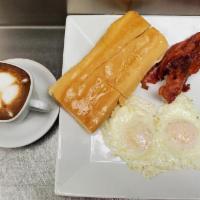 El Tradicional · 2 eggs, any style with a choice of ham or bacon, toast, and cafe con leche.