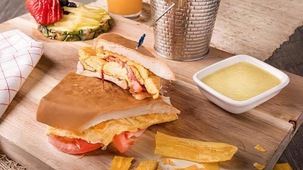 Breakfast Sandwich · 2 eggs any style with a choice of ham or bacon on a toasted cuban bread served with café con leche.