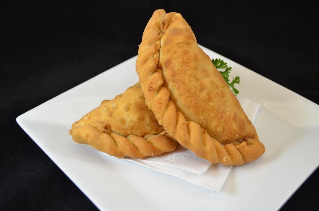 Empanada. · Cuban turnover filled with ham & Swiss cheese, beef, chicken or spinach.