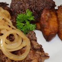Vaca Frita · A flavorful shredded flank steak grilled to perfection, topped with sauteed onions.