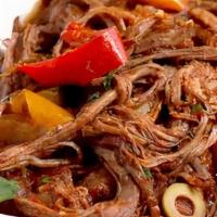 Ropa Vieja · Shredded flank steak stew with onions, peppers, and tomatoes.
