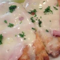 Milanesa De Pollo · Breaded boneless chicken breast topped with marinara sauce, ham and melted mozzarella cheese.