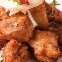 Chicharron De Pollo · Crispy marinated chicken chunks with our special onions and garlic sauce.