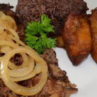 Vaca Frita De Lechon · A flavorful shredded pork grilled to perfection and topped with sauteed onions.