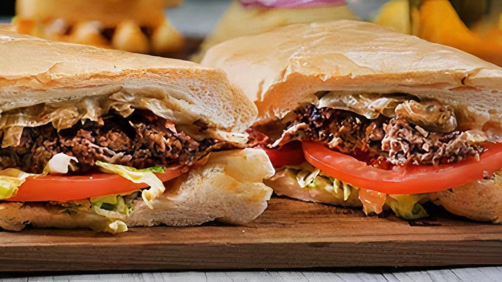 Cuban Vaca Frita Sandwich · Served with melted mozzarella cheese, lettuce, tomato and cilantro garlic aioli sauce.