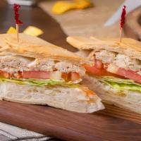 Sandwich De Pollo · Grilled chicken breast, served with lettuce, sliced tomatos and a touch of cilantro garlic a...