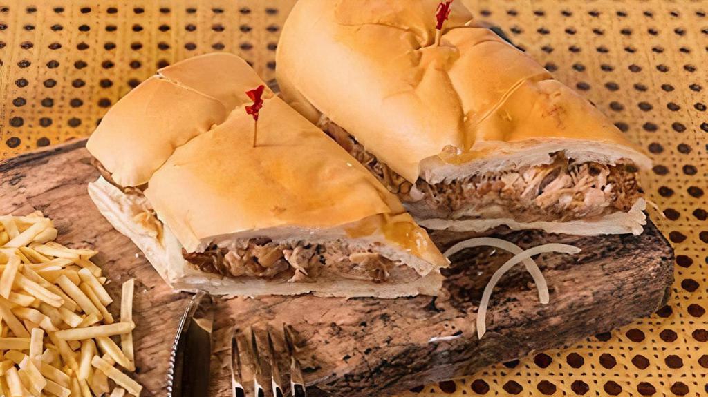 Pan Con Lechon · Roast pork grilled with onions topped with our mojo sauce, served on cuban bread.
