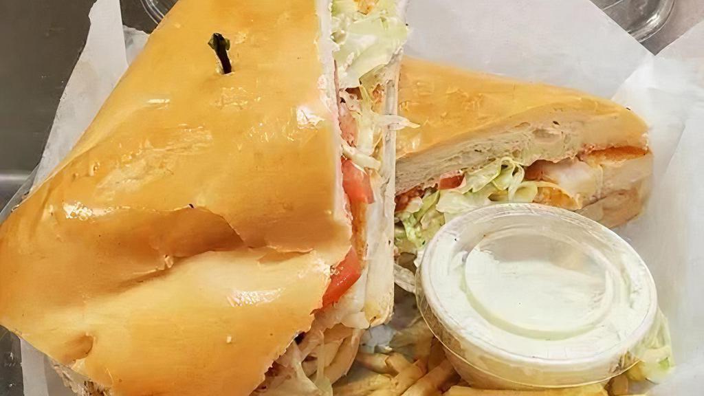 Sandwich De Pescado · Grilled fish filet, served with lettuce, tomatoes and cilantro garlic aioli sauce on toasted cuban bread.