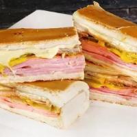 Cubano Regular · Ham, pork, Swiss cheese, pickles and a touch of mustard on Cuban bread served with Mariquitas.