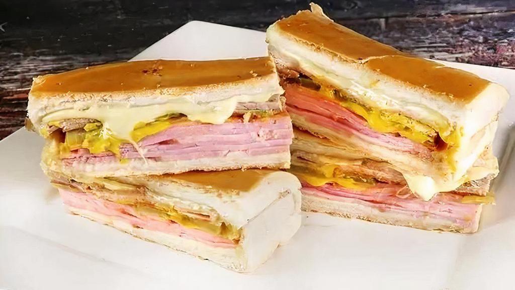 Cubano Regular · Ham, pork, Swiss cheese, pickles and a touch of mustard on Cuban bread served with Mariquitas.