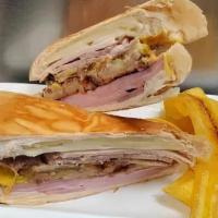 Croqueta Preparada · Ham, pork, swiss cheese, two croquettes and pickles with a splash of mustard on cuban bread ...