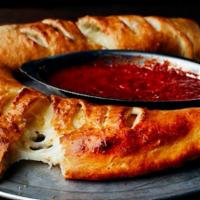 Calzone · Ricotta and mozzarella cheese, spices, fresh garlic baked in pizza dough, brushed with garli...