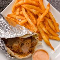 Greek Gyro Sandwich · A blend of seasoned beef and lamb wrapped in a warm pita topped with lettuce, tomato, and tz...
