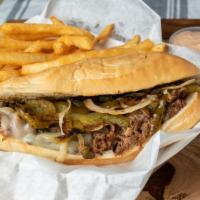 Philly Cheese Steak Sandwich · Shaved ribeye marinated and seasoned grilled with onions, bell peppers, and mushrooms with m...