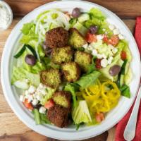 Falafel Salad · Vegetarian. Our homemade falafel served on top of fresh greens, with diced tomatoes, diced c...