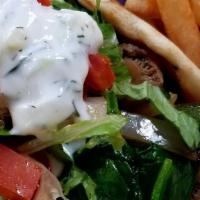 Vegetarian Gyro (V) · Grilled peppers, onions, mushrooms, spinach, wrapped in a pita with lettuce, tomato, and a s...