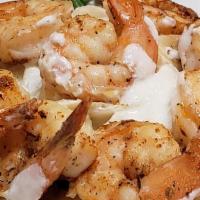 Shrimp Alfredo · Seasoned broiled shrimp tossed in a creamy alfredo sauce served over fettuccine