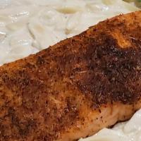 Blackened Salmon Alfredo · Blackened salmon filet topped with a creamy alfredo sauce served over fettuccine