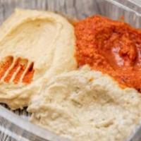 Mix Arabian Dips · Hummus, baba ganoush, and roasted red pepper dips degustation with natural pita bread and pi...