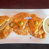 Trio Empanadas · Three fried pastries filled with your choice of guava and cheese, cheese, beef, chicken, ham...