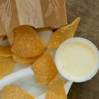 Chips And Queso · 4 oz. white queso served with tortilla chips.