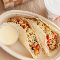 Kid'S Chicken Tacos · Two chicken tacos on flour tortillas. Served with tortilla chips, 2oz Queso and your choice ...