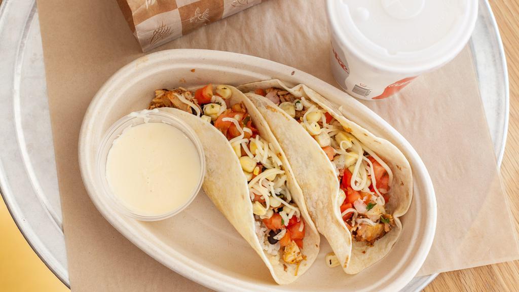Kid'S Chicken Taco · 2 tacos served with chips, queso and choice of drink.