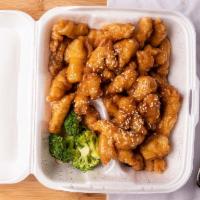Sesame Chicken · Crispy fried sliced chicken sautéed in a sweet brown sauce, topped with sauce.