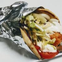 Fried Chicken Gyro Wrap · Fried chicken wrapped in pita bread with hummus, lettuce, red onions, tomatoes, and topped w...