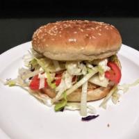 Veggie Burger · Grilled veggie patty with lettuce, tomatoes, red onions, Swiss cheese, and mayonnaise on a t...