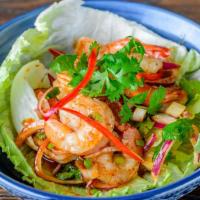 Jumping Shrimp · Shrimp cooked in a spicy paste, lime juice, scallion, red onions, and cilantro.