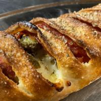 House Stromboli · Grande Mozzarella cheese, pepperoni, sausage, green peppers and onions.