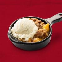 Homemade Peach Cobbler · Southern-style cobbler served with a scoop of vanilla ice cream.