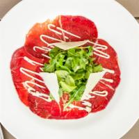 Bresaola E Rucola · Thin sliced lean dry salted beef from the Valtellina, arugula, shaved Parmigiano Reggiano, a...