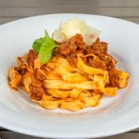 Pappardelle Alla Bolognesa · Homemade pappardelle pasta, ground beef and veal ragu sauce.