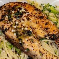 Herb Salmon Pasta · Fresh steak cut of salmon pan seared coated with a lemon herb butter served over a bed of sp...