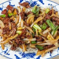 Mongolian Beef · Sliced tender beef sauteed with white and green onions garnished with rice noodles in specia...