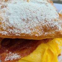 Beignets Breakfast Sandwich · Bacon, French tortilla with Smartbean Cheese Blend (Sharp Cheddar, Colby, Monterey, White Ch...