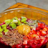 Pitaya Bowl · Blend of dragon fruit, mango, and strawberries topped with kiwi, chocolate, peanut butter, c...