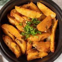Phoenician Fries App · Wedge fries sautéed in lemon juice, olive oil, garlic and cilantro.