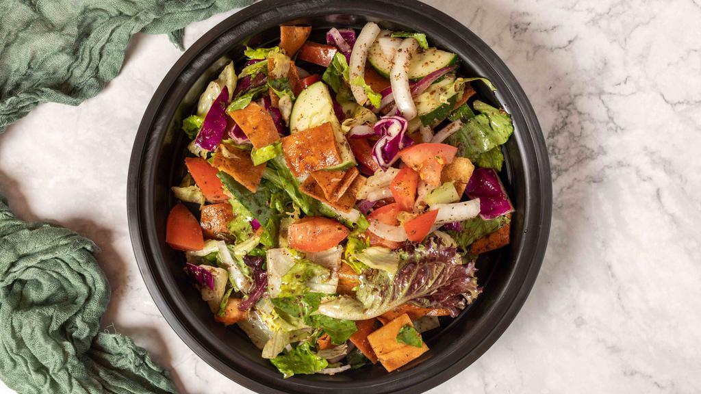 Fattoush Salad · Assorted greens, tomatoes, onions, cucumbers, and pita chips tossed with our house sumac dressing.