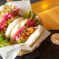 Pork Belly Buns · Crispy pork belly with kimchi sauce and Asian coleslaw