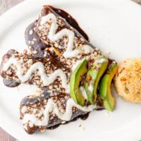 Mole · Corn tortilla filled with shredded chicken, rice, covered in our homemade mole sauce. Topped...
