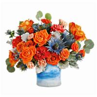 Standout Chic · Tres chic! This high-fashion mix of bold orange roses and eye-catching blue eryngium, arrang...