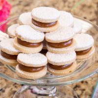 Alfajores · (12 units)
Two vanilla cookies filled with dulce de leche topped with powdered sugar.