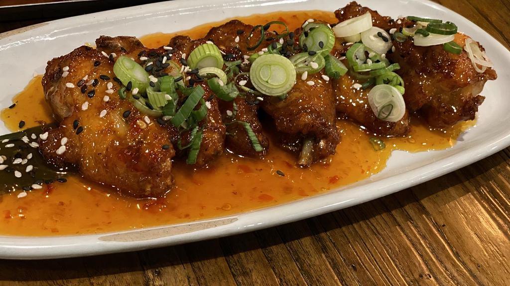 Sweet Chili Chicken Wings · Fried chicken wings glazed in sweet and spicy Asian sauce.