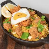 Arroz Con Pollo · Venezuelan style creamy rice with fried and grilled chicken, fried egg, and green peas.