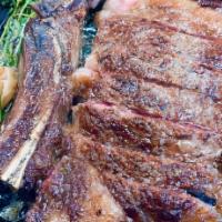 Porterhouse Cazuela · 22 ounces grilled Porterhouse steak served in a hot pot cazuela with roasted garlic, thyme, ...